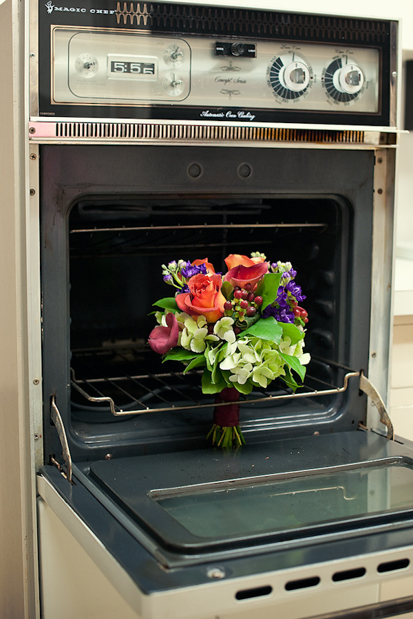 interesting display of a floral bouquet standing in an open oven - photo by Houston based wedding photographer Adam Nyholt 